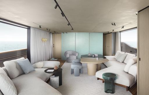 Sanlorenzo SD90 main salon, with cream sofas to port and starboard and coffee table centre.