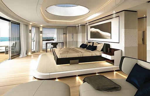 double bed on a raised platform with skylight above and 180-degree views through full-length glass windows in the master suite on board Sanlorenzo 64 Steel yacht