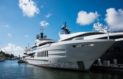 Superyachts moored at Superyacht Village FLIBS, surrounded by marina and blue sky