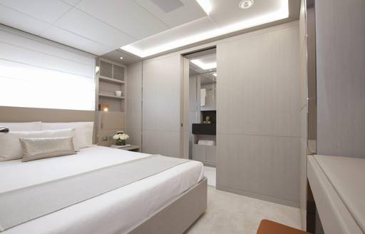 A double guest cabin onboard a Benetti motor yacht, double berth and a large storage cupboard