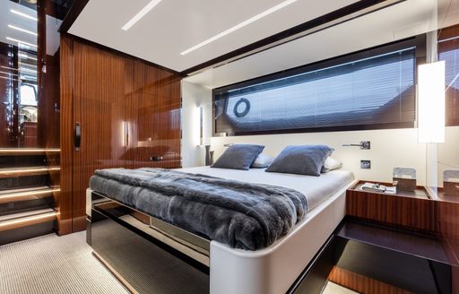 Double bed in wooden detailed cabin on 56' Rivale Hard Top