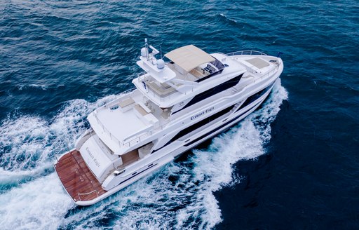 Elevated view of Horizon FD92 tri-deck, aft deck in view with yacht underway, surrounded by sea