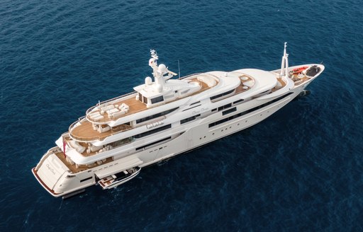 CRN superyacht CHOPI CHOPI shown aerial view over starboard quarter and along side profile in calm sea, tender garage door open with tender being either launched or recovered