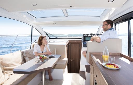 people relaxing in a deck salon wheelhouse 