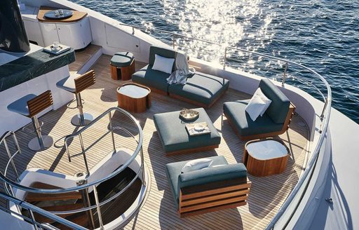 Exterior seating arrangement on Magellano 25 Metri flybridge, with wetbar to port side, overlooking the sea