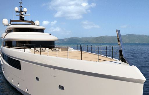 Close up of bow on Benetti Project Rinascimento, with sea and mountains in background