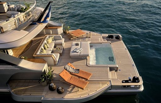 Overview of Benetti Oasis 40m Beach Club, infinity pool centre, surrounded by sun loungers.