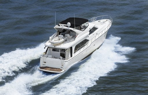 starboard aft aerial shot of fast motor cruising yacht