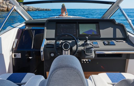 Chase boat helm with steering wheel and technical instruments visible