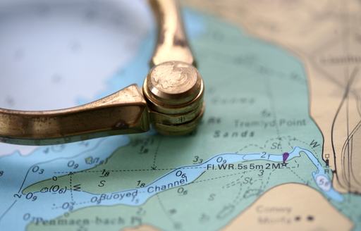 close up of dividers on nautical chart