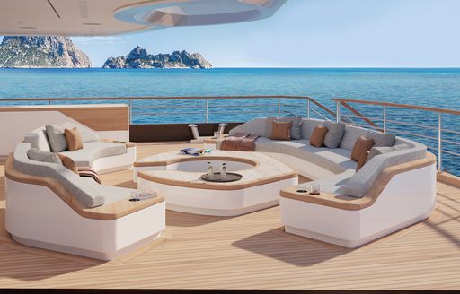 Exterior seating area onboard the Moonflower 72, circular seats surround a coffee table, with sea visible all around.