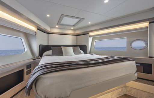 VIP cabin onboard Absolute 50Fly, central berth surrounded by windows