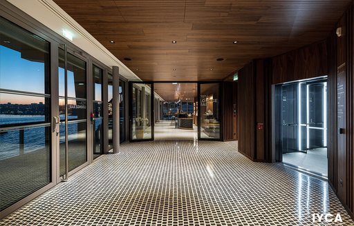 Overview of an interior corridoor at the  International Yacht Club d’Antibes (IYCA). Extensive windows to left hand side. 