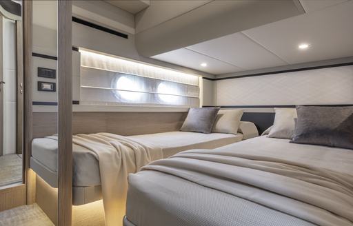 Twin cabin onboard Absolute 50Fly, two single berths with porthole windows to port side