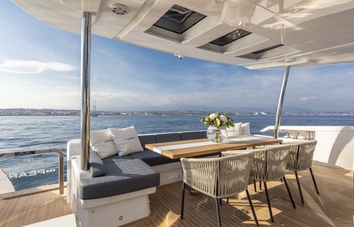 The alfresco dining section on board a Pearl 95 motor yacht.