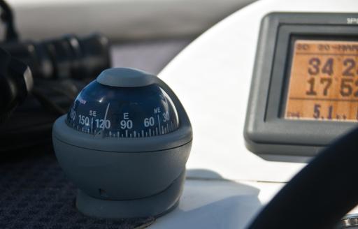 compass with chart plotter in background