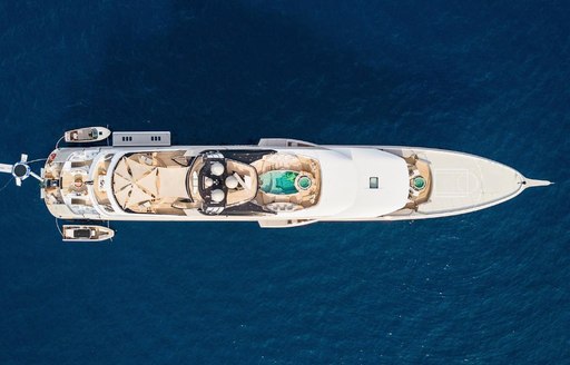 Aerial bird's eye view of Superyacht KISMET. Overlooking entire length of yacht with swimming pool and decks visible.