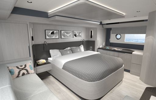 Master cabin onboard Sirena 48, central berth with wide glazing in background and white sofa in foreground.