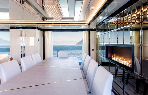 Salon with formal dining area and real fire on superyacht STEFANIA 