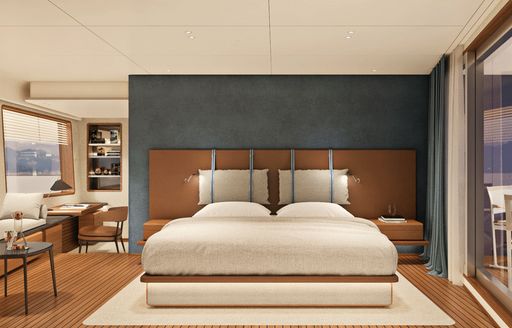 bed with white linen in master suite of Navetta 30 with full-length windows, teak floorboards and grey wall panels