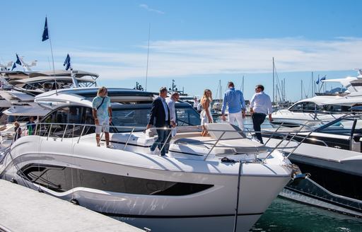 A Princess yacht with people exploring the bow at the Cannes Yachting Festival