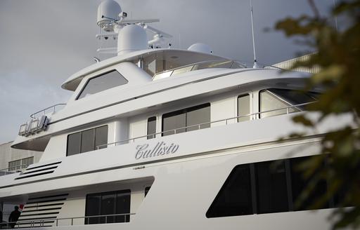 Close up view of Feadship CALLISTO nametag on starboard side of superyacht.