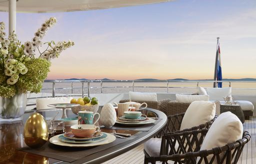 Sky deck onboard Heesen 'Project Triton', al fresco dining table and chairs, overlooking sea