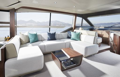 Light and airy interior on Princess F62, with large sofa and table