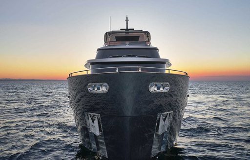 Face on view of Magellano 25 Metri looking directly at bow, surrounded by sea at sunset