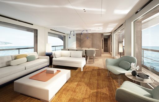 Maon salon onboard Azimut Grande 26 Metri, angular seating situated around edges facing in towards low down coffee table. Large windows surrounding. 