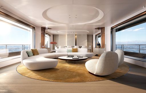 Main salon onboard Azimut Grande 36 Metri, seating curved around a central coffee table, large windows on either side.