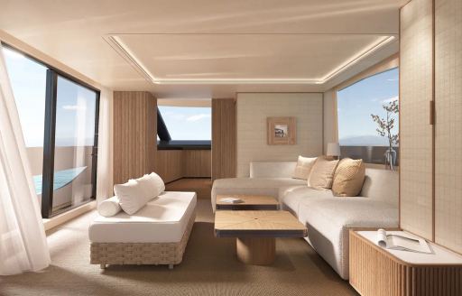 Main salon onboard Seadeck 7, white seating to starboard with large open sliding door to port side.