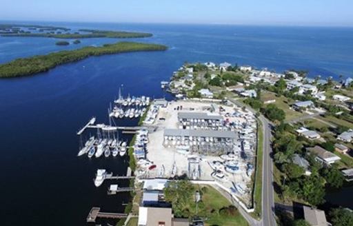 Aerial view of Shell Point Marina – Tampa Bay, multiple boats and yachts moored, surrounded by sea and green foliage