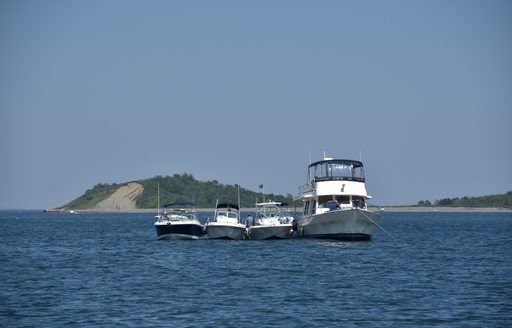 small boats rafted up on anchor