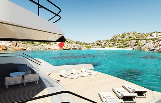 oversized swim platform with sun loungers on situated on aft of the Maori 125 yacht anchored in blue waters