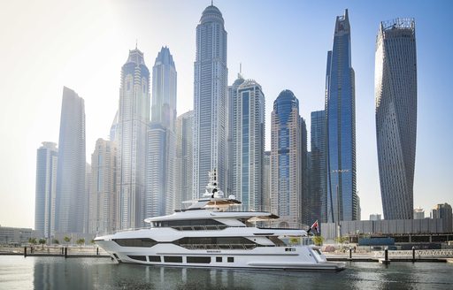 Gulf Craft Majesty 120 entering Dubai Harbour Marina, overlooking Dubai skyscrapers