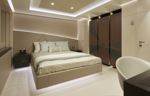 Guest cabin onboard Heesen 'Project Triton', central berth with office desk opposite