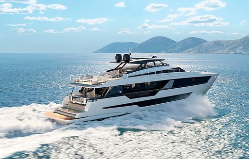 Side angle view of Ferretti 1000 underway, surrounded by sea with land in far distance 