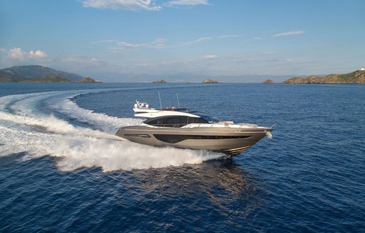 Princess S66 underway, surrounded by sea and islands in far distance.