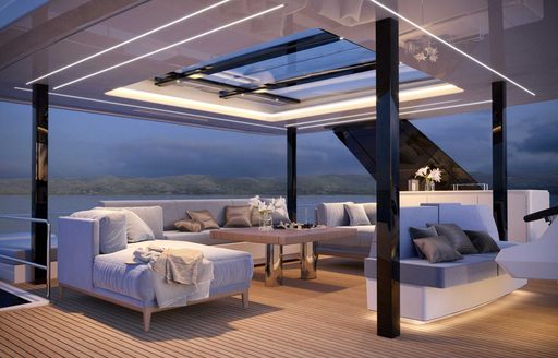 Sunreef Yachts Power ECO 60 night time shot with stylish illumination through exterior salon shown with freestanding furniture