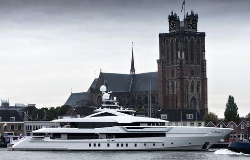 Heesen superyacht LUSINE on water in front of building