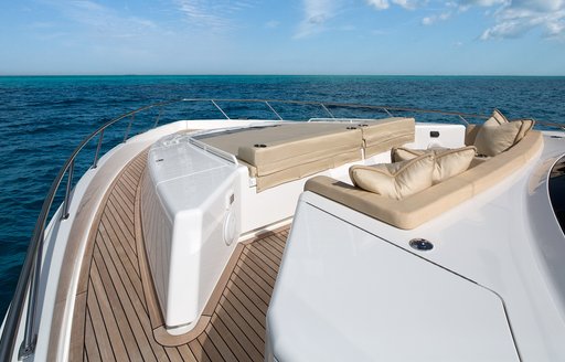 Bow area onboard Viking 75 MY, sunpads and padded seating facing forward, surrounded by sea.