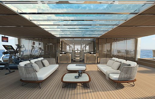 two white sofas face each other with coffee tables in between and glass-bottomed pool above on the main deck aft of Sanlorenzo 64 Steel yacht