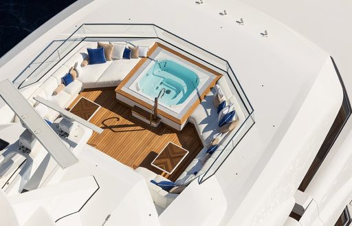 Sun deck onboard superyacht MADSUMMER, on deck Jacuzzi surrounded by plush seating. 