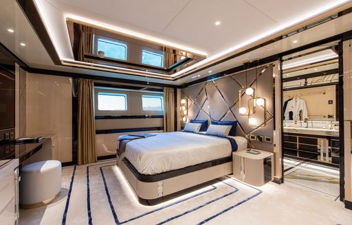 Large double bed in cabin on superyacht STEFANIA with ensuite visible