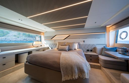 Overview of the master cabin onboard the Sunseeker 75 Sport Yacht, central berth facing forward with a window to both port and starboard