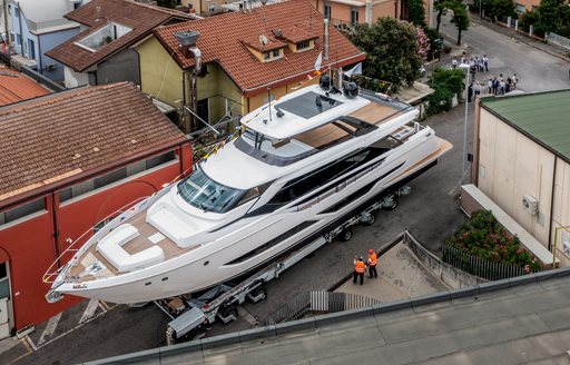 Elevated view of Ferretti Yachts 860 on tarmac. Surrounded by buildings.