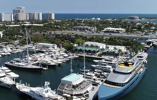 Motor yachts moored at Pier 66 Marina – Fort Lauderdale, with towering hotels and sea in background