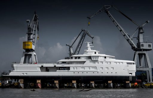  Damen Yachting's 'La Datcha' Explorer Yacht under construction, with cranes in background