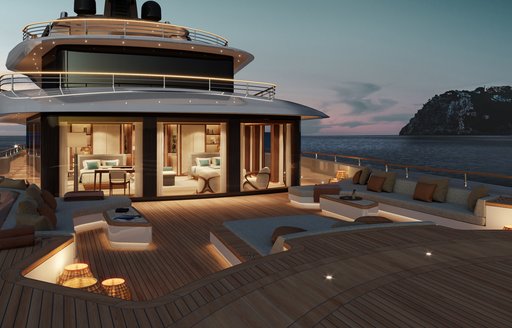 Overview of the upper deck exteriors onboard Moonflower 72 at dusk, lights switched on in the interiors reveal cabins overlooking sunloungers and vast deck space.